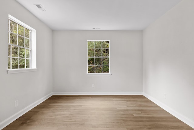 spare room with light hardwood / wood-style flooring