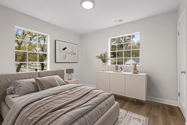 bedroom with dark hardwood / wood-style floors