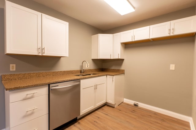 kitchen featuring light hardwood / wood-style flooring, stainless steel dishwasher, white cabinets, and sink