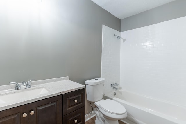 full bathroom with toilet, tiled shower / bath, and vanity