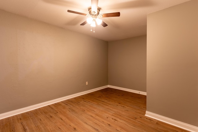 spare room featuring hardwood / wood-style flooring and ceiling fan