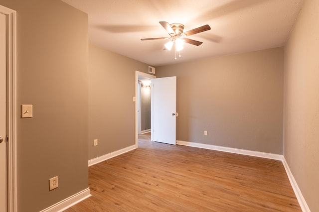 empty room featuring ceiling fan and light hardwood / wood-style flooring