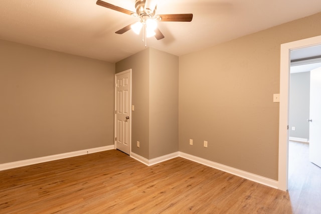 empty room with ceiling fan and light wood-type flooring