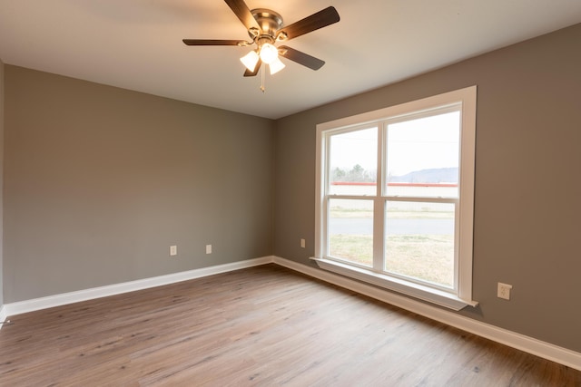 spare room with ceiling fan and wood-type flooring