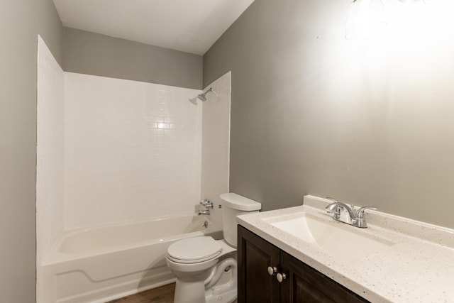 full bathroom with wood-type flooring, toilet, vanity, and shower / washtub combination