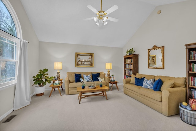 carpeted living room featuring vaulted ceiling and ceiling fan