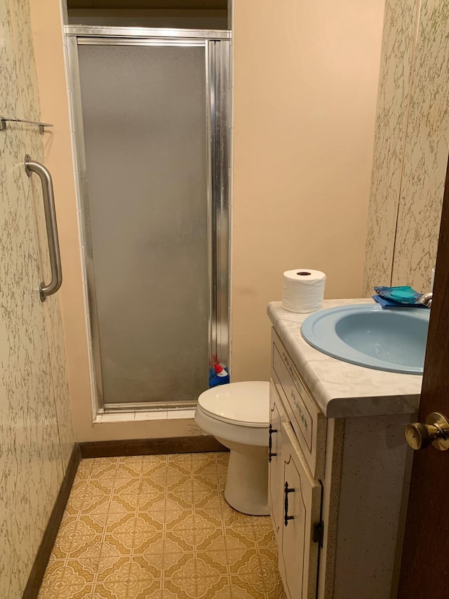 bathroom featuring an enclosed shower, vanity, and toilet