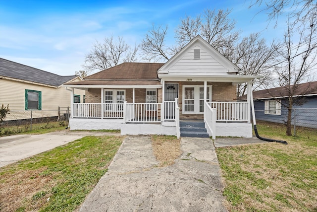 bungalow featuring a front lawn and a porch