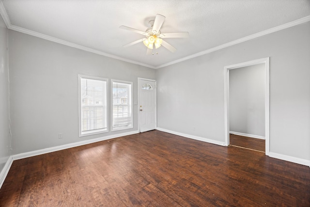 spare room featuring ceiling fan, dark wood-type flooring, and crown molding