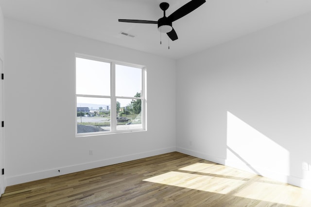 spare room featuring wood-type flooring and ceiling fan