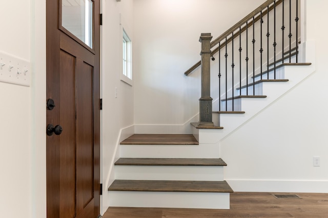 stairs with hardwood / wood-style flooring