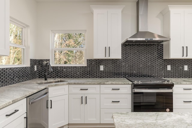 kitchen with stainless steel dishwasher, stove, wall chimney exhaust hood, and white cabinets