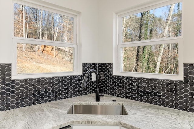 details featuring light stone countertops and sink