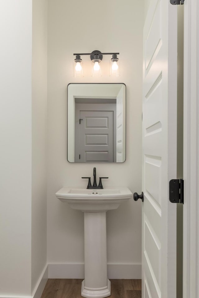 bathroom with hardwood / wood-style floors