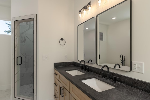 bathroom with walk in shower and vanity