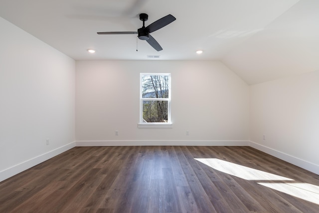 additional living space featuring ceiling fan, dark wood-type flooring, and vaulted ceiling