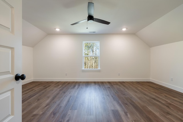 additional living space with ceiling fan, vaulted ceiling, and dark wood-type flooring