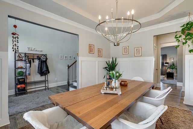 dining area featuring a notable chandelier, crown molding, dark hardwood / wood-style floors, and a raised ceiling