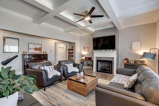 living room featuring beamed ceiling, ceiling fan, and coffered ceiling