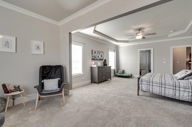 bedroom with crown molding, a raised ceiling, ceiling fan, and carpet flooring