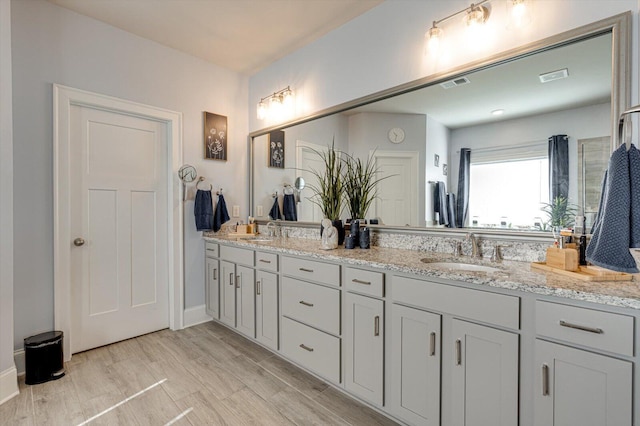 bathroom featuring hardwood / wood-style flooring and vanity