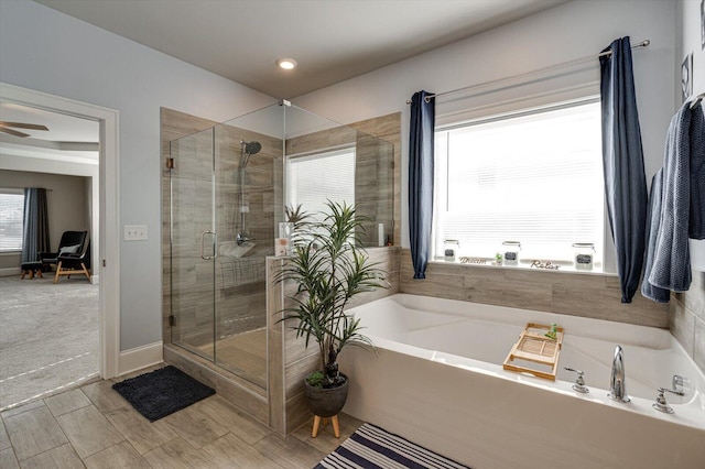 bathroom with plenty of natural light, independent shower and bath, and ceiling fan