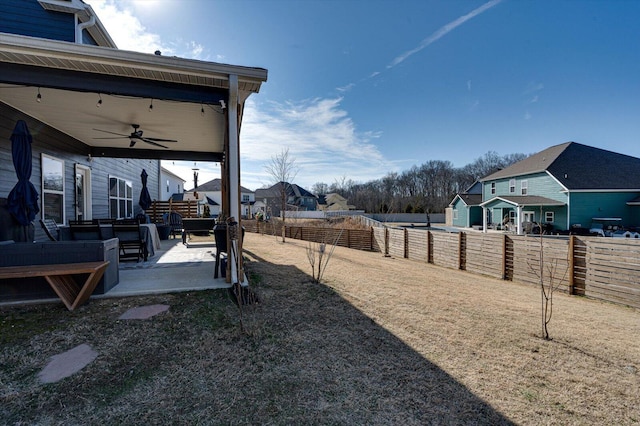 view of yard with ceiling fan and a patio