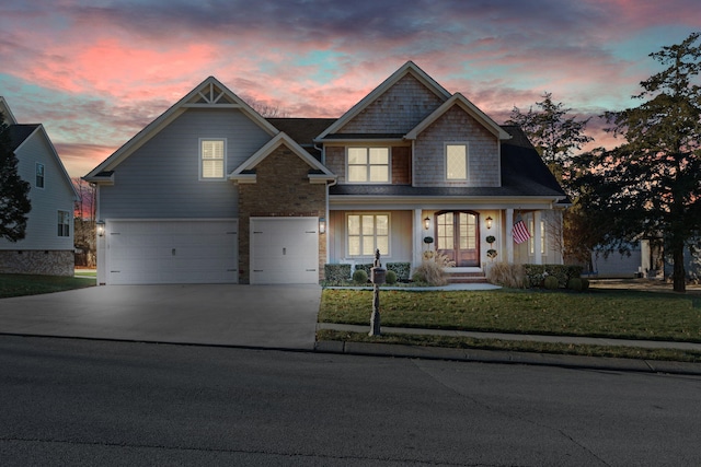 craftsman house with a lawn and a garage