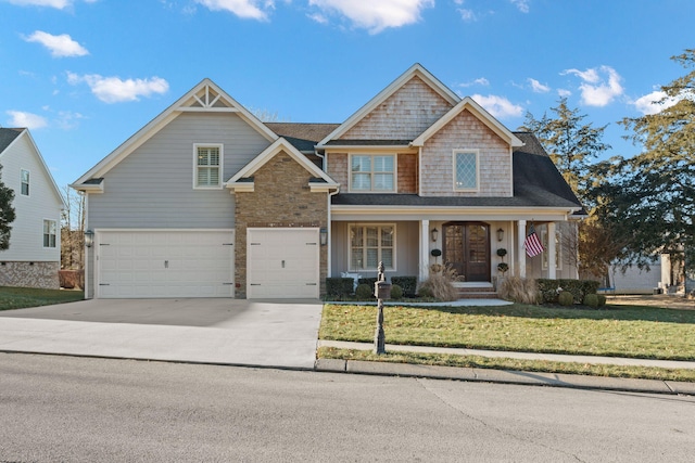 craftsman house with a garage, a front yard, and a porch