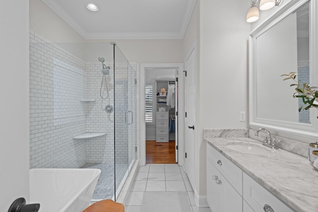 bathroom featuring tile patterned flooring, vanity, crown molding, and shower with separate bathtub