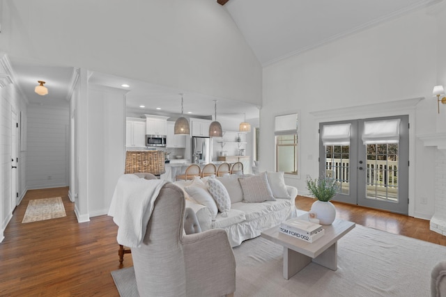 living room with dark hardwood / wood-style floors, beamed ceiling, french doors, and high vaulted ceiling