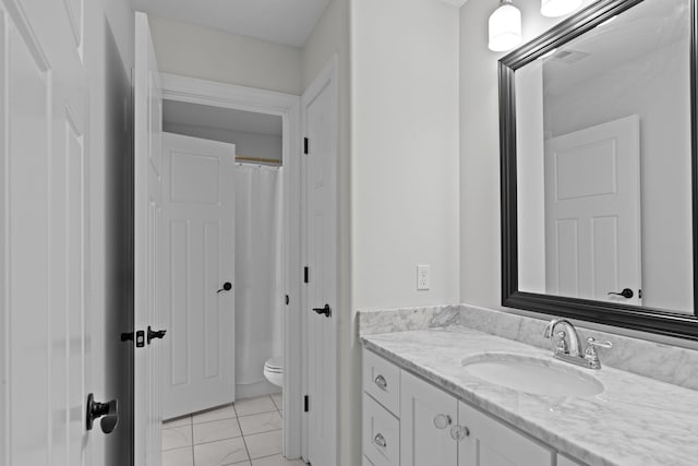 bathroom featuring toilet and vanity