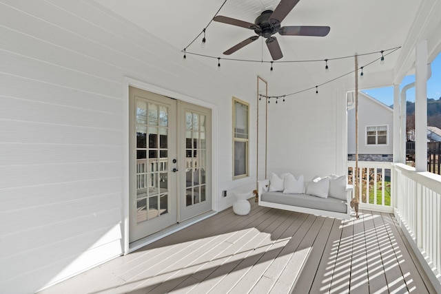 wooden deck featuring ceiling fan and french doors