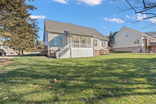 rear view of house with a yard