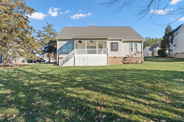 rear view of house featuring covered porch and a yard