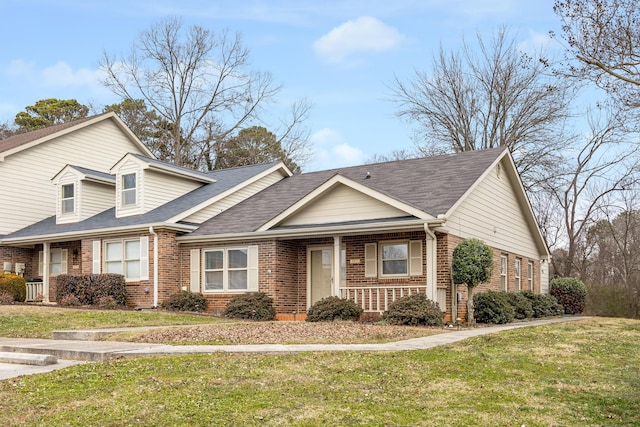 view of front of home with covered porch and a front yard