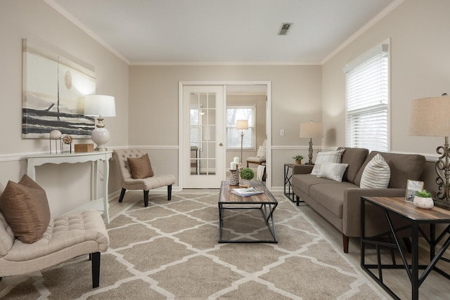 living room featuring crown molding and french doors