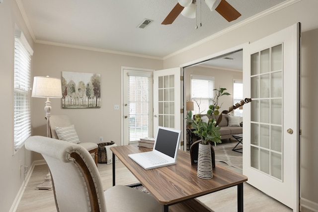 office area featuring ceiling fan, a healthy amount of sunlight, crown molding, and light hardwood / wood-style floors