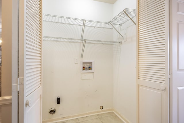 clothes washing area featuring washer hookup, light tile patterned floors, and hookup for an electric dryer