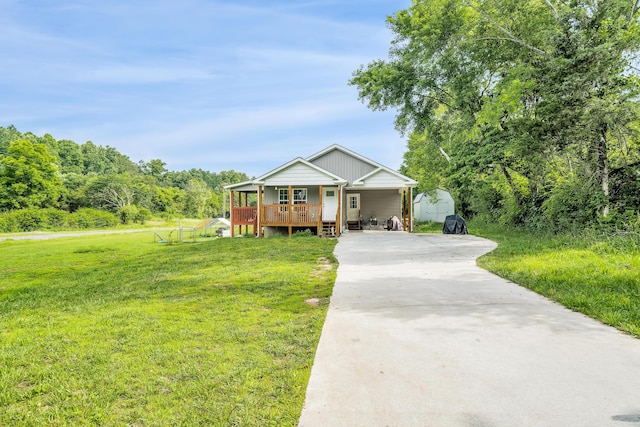 view of front of property with a front lawn, a storage shed, and covered porch