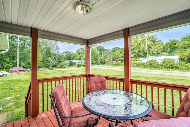 wooden deck featuring a yard