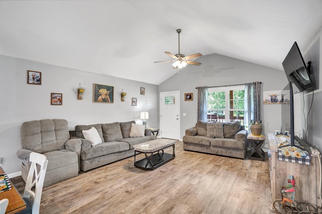 living room with ceiling fan, light hardwood / wood-style flooring, and vaulted ceiling