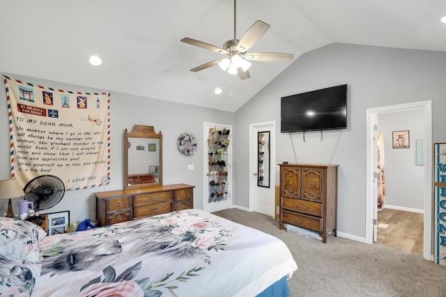 bedroom with ceiling fan, ensuite bath, vaulted ceiling, and carpet flooring