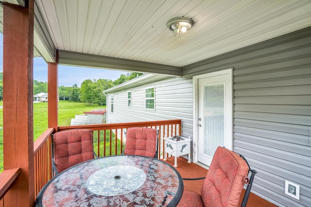 wooden deck featuring a lawn