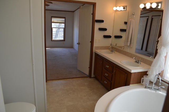 bathroom with a washtub and vanity