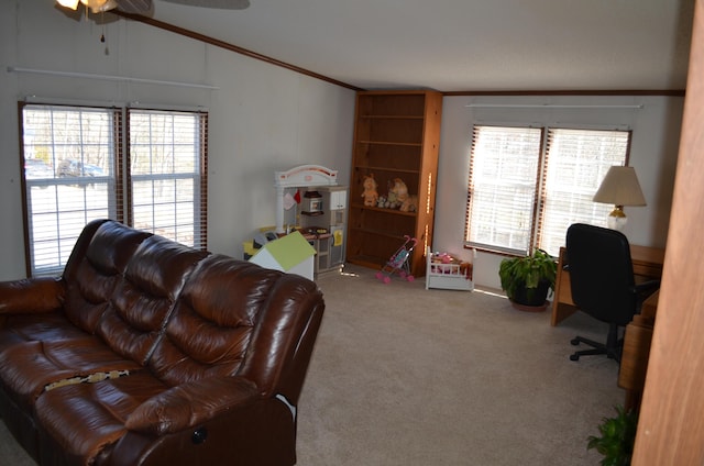 carpeted living room with ceiling fan, ornamental molding, and vaulted ceiling