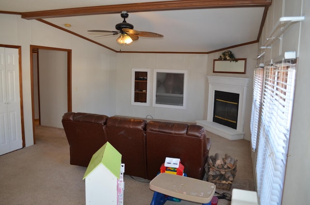 living room with ceiling fan, light carpet, vaulted ceiling, and crown molding