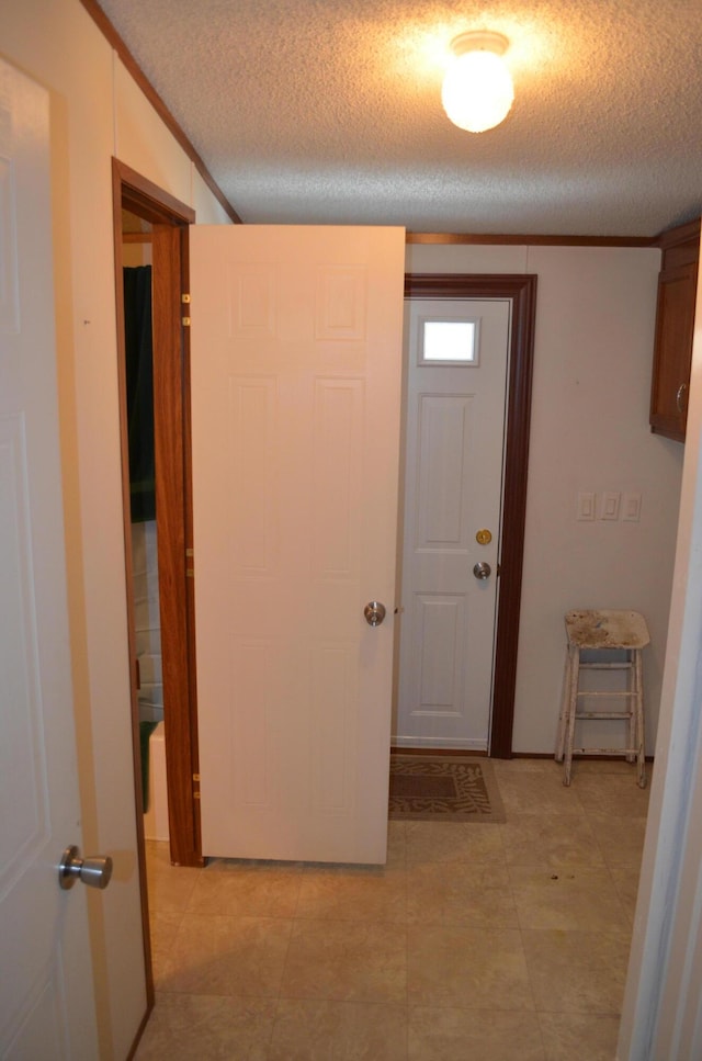 hall with a textured ceiling