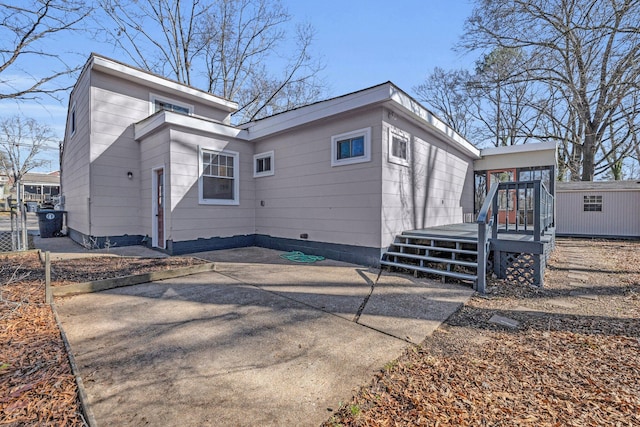 view of property exterior featuring a wooden deck and a sunroom