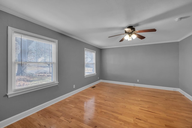 empty room featuring ceiling fan, light hardwood / wood-style flooring, and ornamental molding